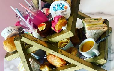 Colourful afternoon tea arranged on tiered display at Happy Bunnies.