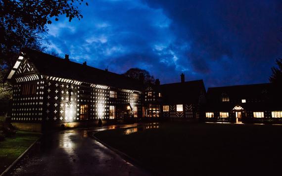 Samlesbury Hall lit up in the dark.