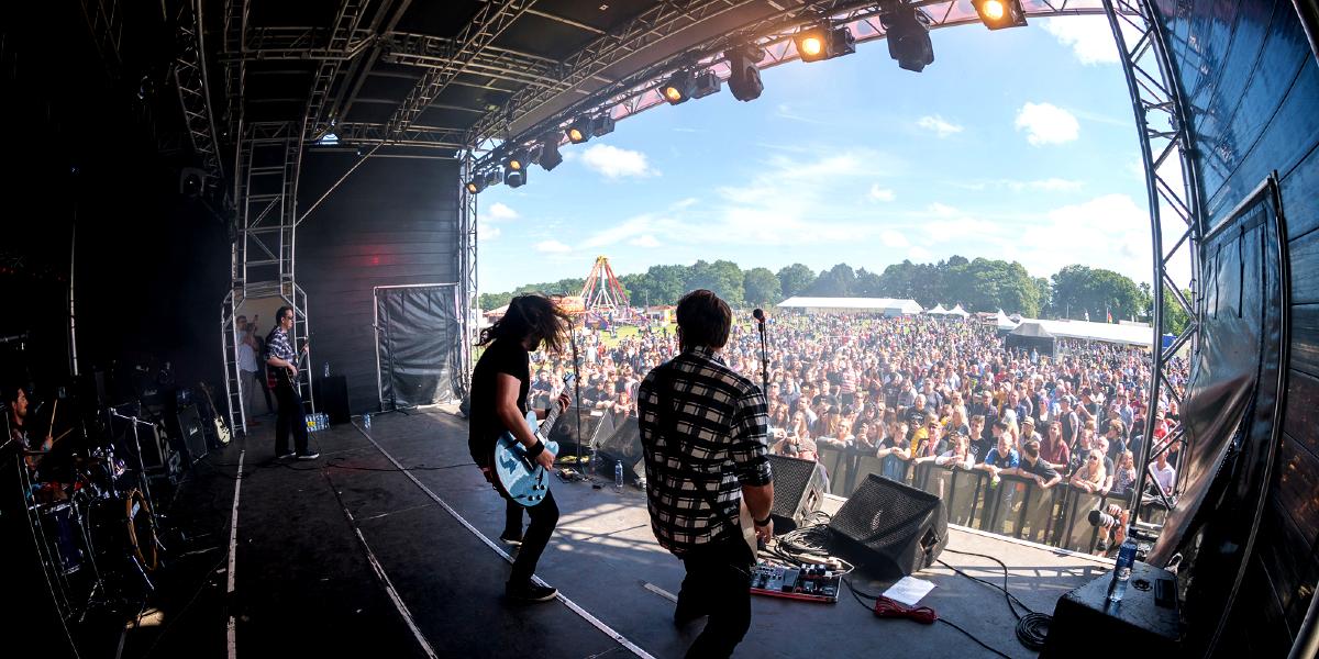 View of crowd from stage where band at Rockprest are performing. 